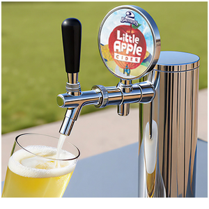 Chrome beer tap pouring a drink into a glass with 'Little Apple Cides' branding.